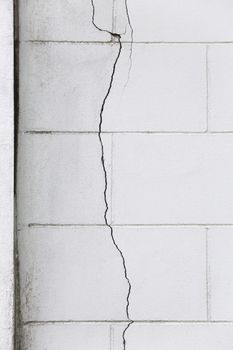 Cracked concrete brick wall in vertical direction