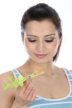 Model Released. Woman Eating Celery and Peanut Butter