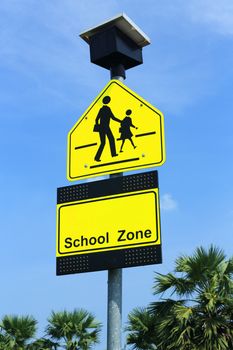 School zone sign, drive slowly and be careful student walking cross the road