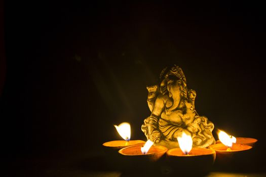 lord ganesha with oil lamp light