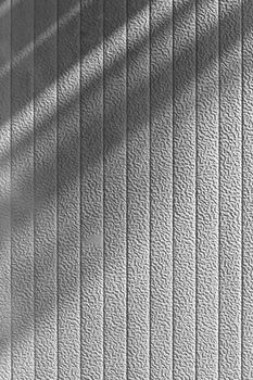 Gray wall background in shadow