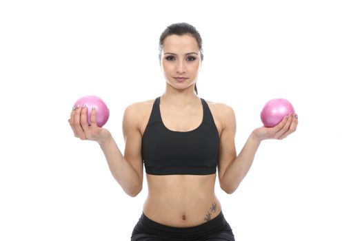 Model Released. Woman Exercising with Toning Balls