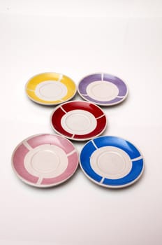 small plates of various colors to put the cup of coffee