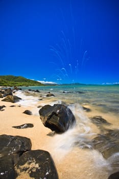 Rocky seashore over the bright blue sky in a landscape view