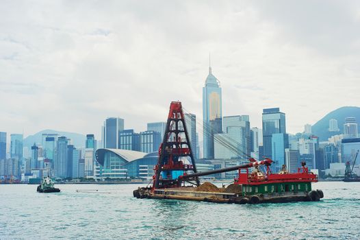 Barge in front of business district in Hong Kong. Some 456,000 vessels arrived in and departed from Hong Kong during the year, carrying 243 million tonnes of cargo 