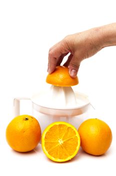 juicer with oranges on a white background