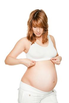 Pregnant woman looking down at bra, isolated on white