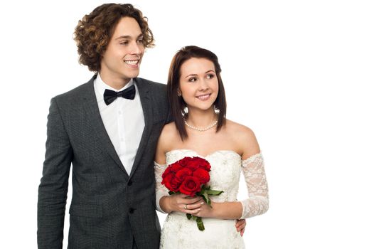 Beautiful young couple looking outside over white