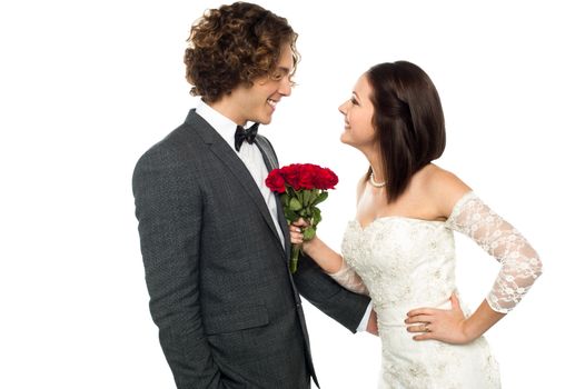 Young beautiful couple admiring each other. Girl holding rose bouquet