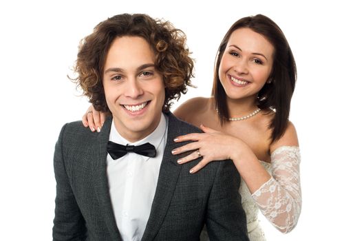 Pretty bride standing behind the handsome groom, love couple