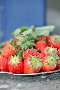 Close-up of freshly picked sweet strawberries on a stone table