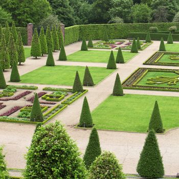 Formal ornamental garden with grren plants and a geometrical layout