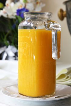 Jug of freshly squezzed orange juice on breakfast table