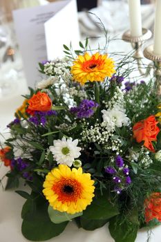 Colorful flower centerpiece on a table set for a formal meal