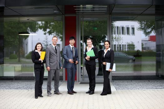Business colleagues standing outside the office building