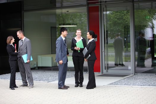 Business colleagues talking with two business couple on the side