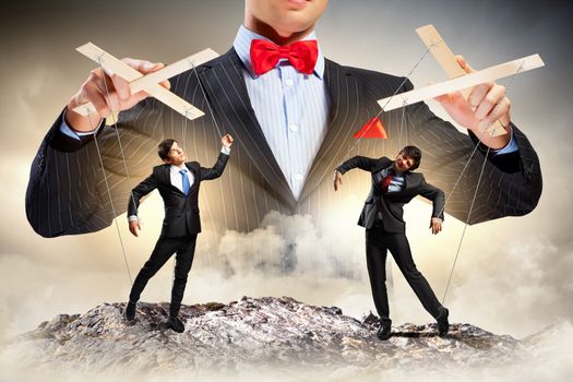 Image of young businessman puppeteer. Leadership concept