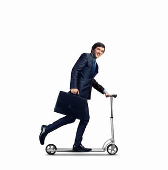 Image of young businessman in black suit riding scooter