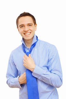 Young businessman at home preparing for a work and making his tie