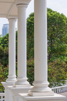 White concrete poles front of the big house