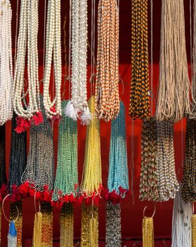 Strands of small colorful beads at the outdoor craft market in India
