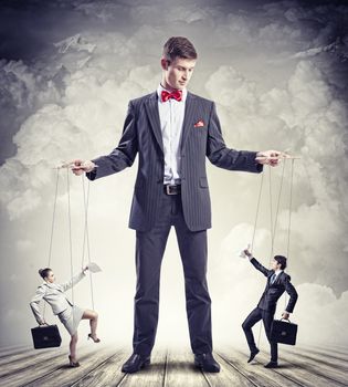 Image of young businessman puppeteer. Leadership concept