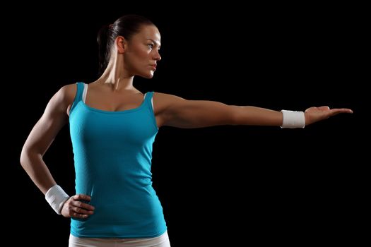 Fitness woman smiling standing against black background