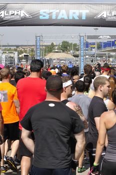 SAN DIEGO, CALIFORNIA - JUNE 15, 2013: Runners gather at the starting line to wait their turn to compete in the Alpha Warrior obstacle course in San Diego on June 15, 2013