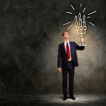 Image of businessman in black suit against dark background