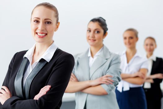 Image of four pretty young businesswomen standing in row