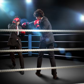 Two young businessman boxing againts dark background . conceptual collage