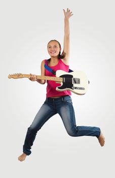 young woman playing on electro guitar and jumping