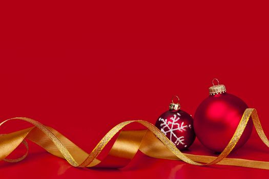 Red Christmas background with ornaments and gold ribbon