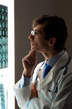 Image of male doctor looking at x-ray results