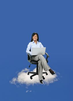 Smiling black businesswoman sitting in office chair on cloud with laptop computer