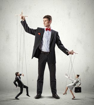 Image of young businessman puppeteer. Leadership concept