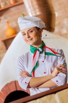 Image of young woman cook standing at kitchen