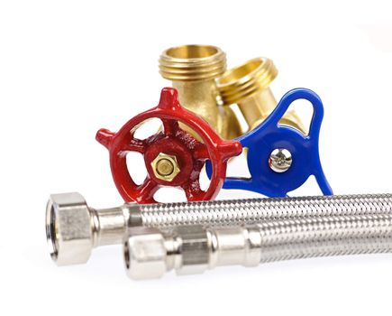 Blue and red plumbing valves with metal hoses