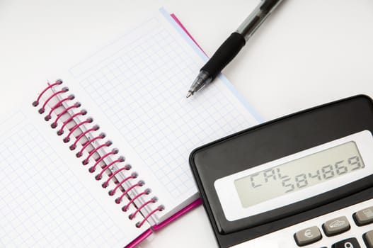 calculator with notepad and pen on a white background