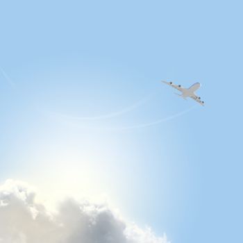 Image of flying airplane in clear sky with sun at background