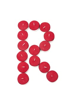 Letter R formed by candles on a white background