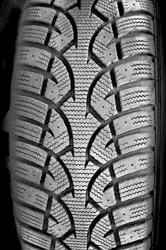 Closeup on rubber tire tread of car wheel