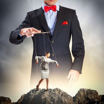 Image of young businessman puppeteer. Leadership concept