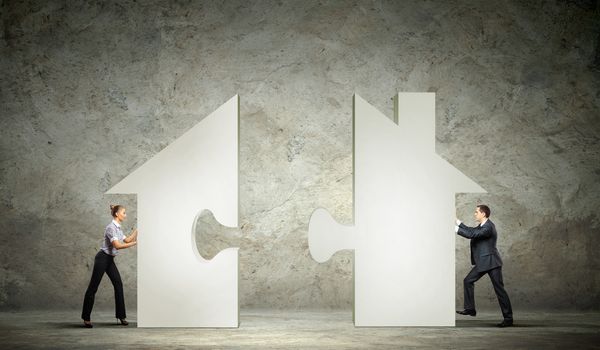 Man and woman connecting house puzzle symbol