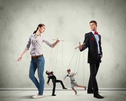 Image of man and woman with marionette puppets