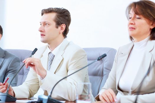 Image of three businesspeople sitting at table