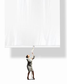 Image of businesswoman pulling blank banner. Place for text