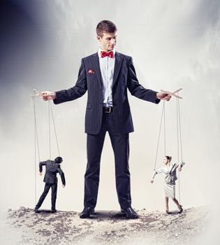 Image of young businessman puppeteer. Leadership concept