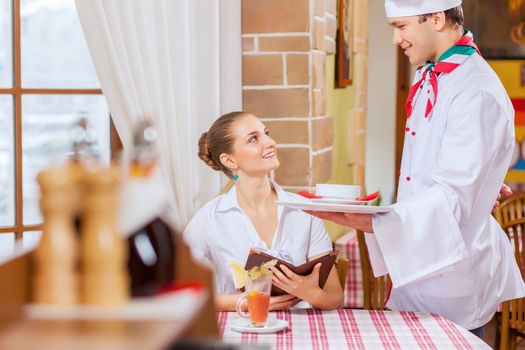 Young woman at restaurant sitting at table