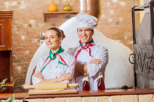 Portrait of two cooks with crossed arms looking at the camera